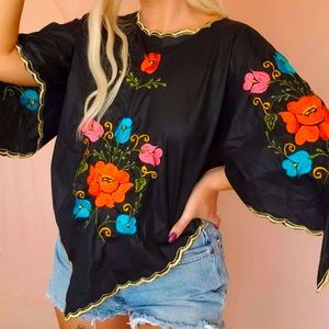 Vintage Embroidered Top with Unique Cut and Vibrant Flowers on Black Background